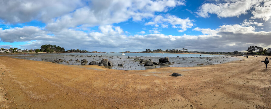 Wide sandy bay with scattered granite rocks in Tregastel Brittany France. Panoramic view