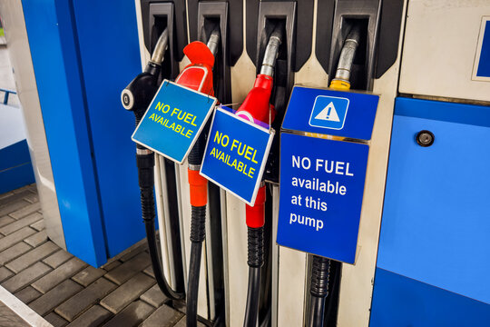 Gas station fuel dispensers with warning signs indicating no fuel availability. Fuel crisis, gasoline shortage, supply problems. translation: fuel nozzle is not working, pump is not working.
