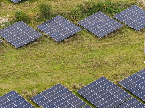 Aerial view of Rathnaskilloge 110kV Solar Farm Substation with rows of photovoltaic panels set in green fields in County Waterford, Ireland.