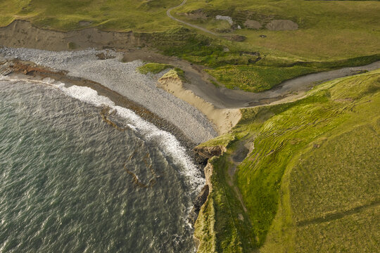 Aerial view of the rugged coastline and pebble beach in Doolin, County Clare, Ireland.