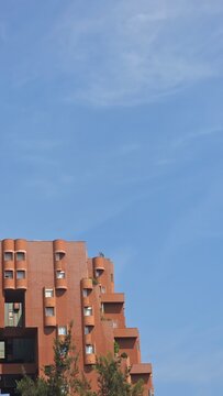 Vertical background of a modern building against a blue sky