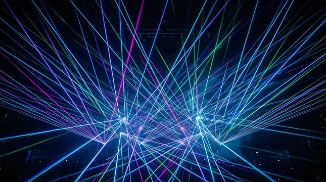Colorful laser light show beams creating geometric patterns in a dark night club background.