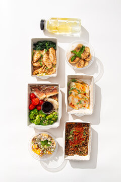 Set of healthy balanced food in disposable eco containers with meat fish vegetables grains and fruit dessert top view