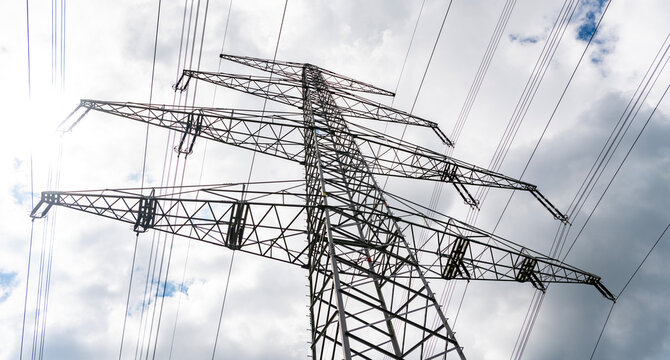 Electric voltage station. High voltage. Electricity power pylon. Electricity tower. Electrical energy. Power transmission tower. Electricity power lines and sky. Green energy