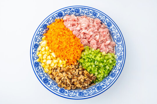 A bowl of pork, vegetable, and mushroom dumpling filling