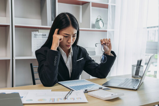 Female employee stressed at work, Businesswoman is worried or stressed about the slump in sales and the company is on the verge of bankruptcy, Sad, Suffering, Fail, bankrupt, Failure of life.