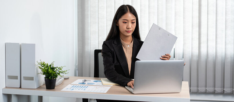 Business woman working on document to reading financial chart an