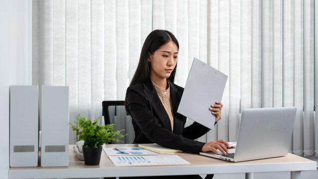 Business woman working on document to reading financial chart an