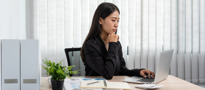 Business woman is reading financial chart to analysis about stra