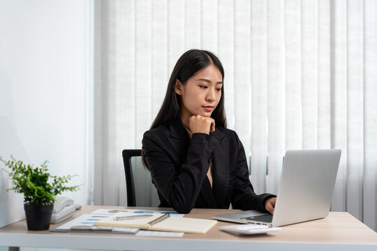 Business woman is reading financial chart to analysis about stra