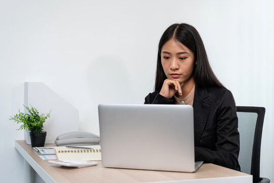 Business woman is reading financial chart to analysis about stra