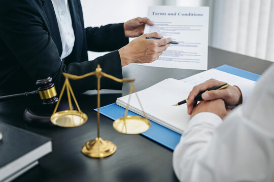 Female lawyer is pointing on legal document to explaining about