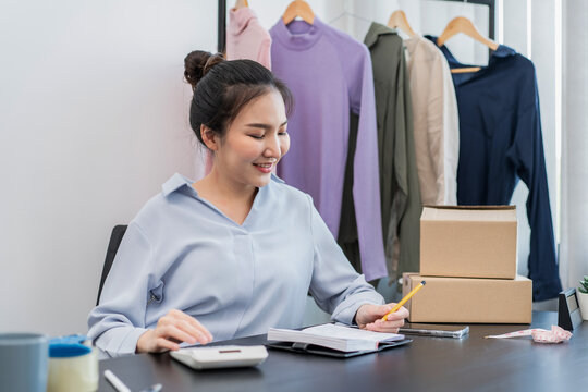 Female fashion designer is calculating the cost of new fashion c