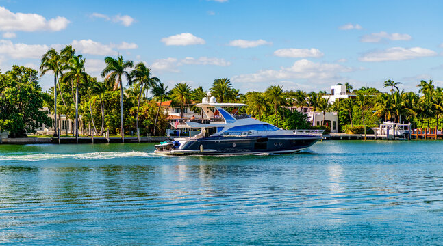 Luxury boat motor yacht in marina. Luxury yacht. Boating and yachting tourism. Luxurious lifestyle. Summer vacation. Docked yacht at private area. Residential luxurious apartment in waterfront city