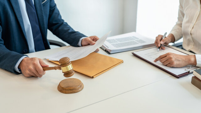 Male lawyer is pointing on legal document to explaining about co