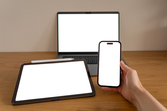 Multi-device digital ecosystem mockups with smartphone, laptop and tablet arranged together, symbolizing seamless connectivity across modern technology