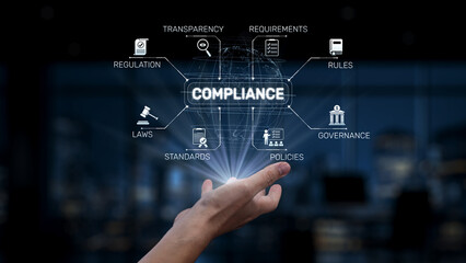 Obraz premium A hand reaches towards a glowing display of compliance keywords, symbolizing the intersection of regulations, governance, and business standards in a dynamic workspace. Synapse
