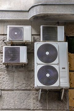 Air conditioners hanging on building facade