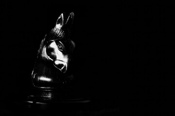 Dramatic Black Chess Knight Piece in Low Key Lighting © teerapon
