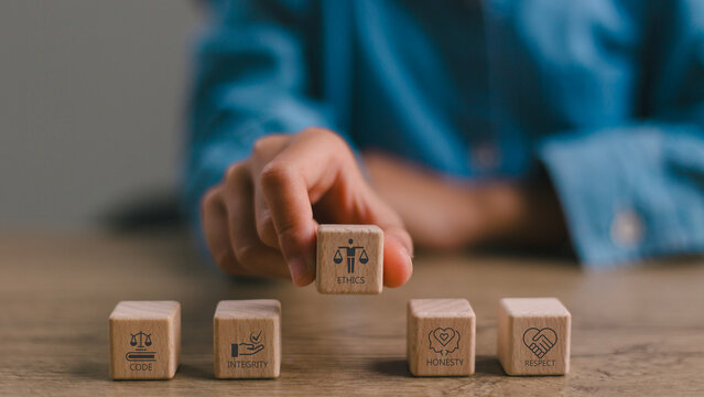 Code of conduct in business concept. Wooden blocks with code of conduct icons%3B code  integrity  honesty  respect  and ethics  the foundation of a strong corporate code of conduct. Corporate ethics.