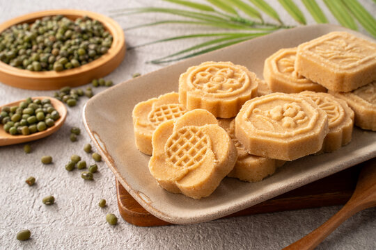 Traditional Chinese peanut mung bean cake with floral patterns on a ceramic plate.