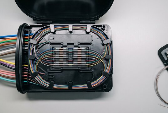 Organized fiber optic splice tray in telecom enclosure