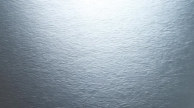 Ocean water surface showing gentle ripples beneath diffuse sunlight reflections