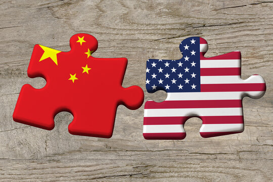 3D illustration. Flag of China and the USA on a jigsaw puzzle pieces on a wood background.