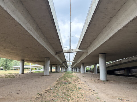 Concrete highway overpass viewed from below with parallel elevated road structures