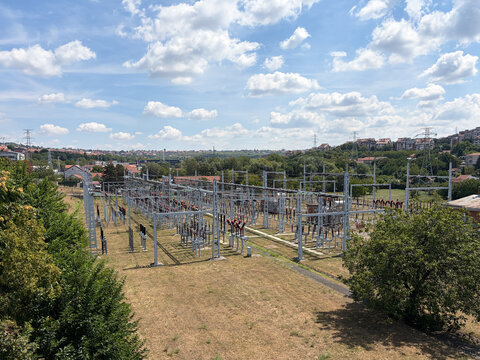 Electrical power substation surrounded by greenery on the edge of a residential city district