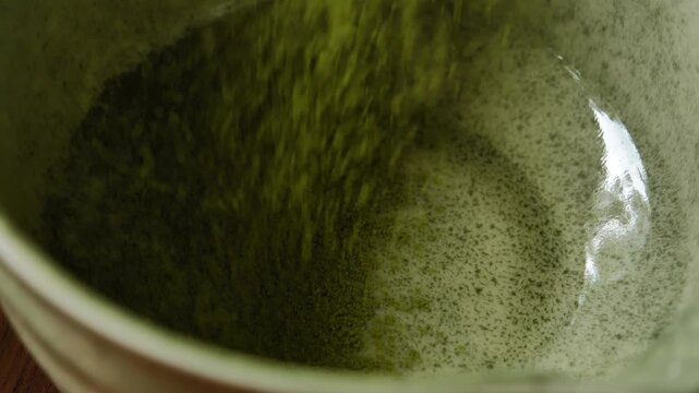 Barista preparing traditional matcha using setting. The scene highlights the careful preparation process, vibrant green matcha, and Japanese-inspired tea culture, making it suitable for beverage, caf&eacute;