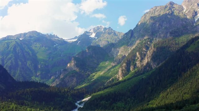 Caucasus valley expands in retreating aerial view above dense forest and the Dolra River near Mazeri, Svaneti, supporting hiking tourism, wilderness travel, regional geography and destination media.