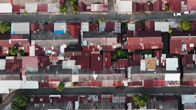 Dense residential district showing rows of houses with rusted metal roofs in Banjarmasin