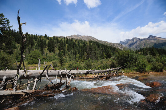 Aone plank bridge across the river in high altitude mountains