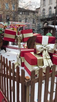 Children posing with elf figures in festive Christmas village