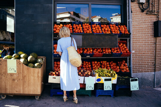 Full Length Mature Blonde Woman Shopping Fresh Produce at Local Spanish Fruit and Vegetable Market