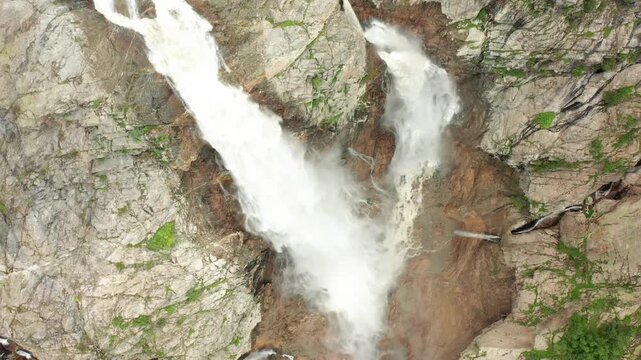 Shdugra Waterfall cascades, aerial view toward a turbulent plunge zone below Mount Ushba near Mazeri, Svaneti, supporting waterfall tourism, hazard awareness, glacier runoff studies, destination media