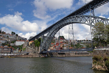 Fototapeta premium View of the historic city of Porto, Portugal with the Dom Luis bridge and blue sky Panoramic view from the city of Porto in Portugal Ancient city Porto,metallic ...
