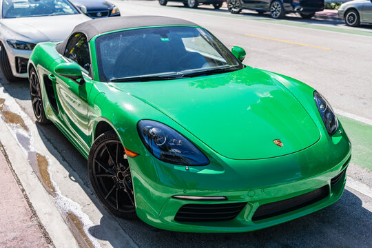 Miami, Florida, USA - December 06, 2025: Porsche 718 Boxster GTC 2021 convertible roadster car. Luxury convertible car Porsche 718 Boxster GTC. Porsche parked outdoor. Green car, corner view