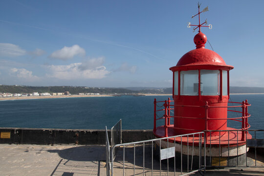 Red lighthouse lamp in Nazare, Portugal.
