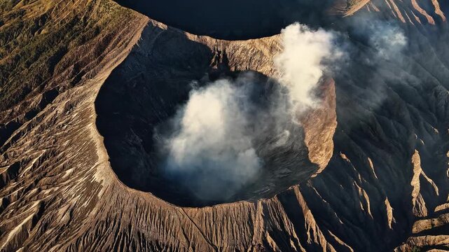 Aerial drone footage flying above the active crater of Mount Bromo volcano, Indonesia