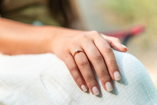 Woman wearing a diamond engagement ring on her finger