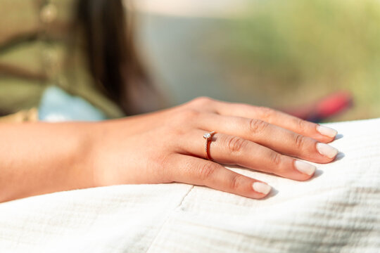 Woman wearing diamond engagement ring symbolizing love commitment
