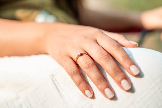Woman wearing engagement ring, symbolizing love and commitment