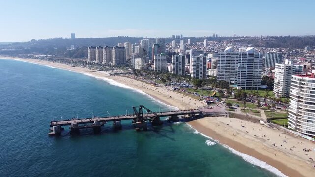 Aerial view of Vergara pier in Vina del Mar Chile with beach and coastal city skyline.