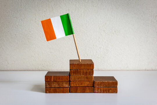 Irish Flag Atop Wooden Steps Symbolizing Achievement and Ambitious Goals