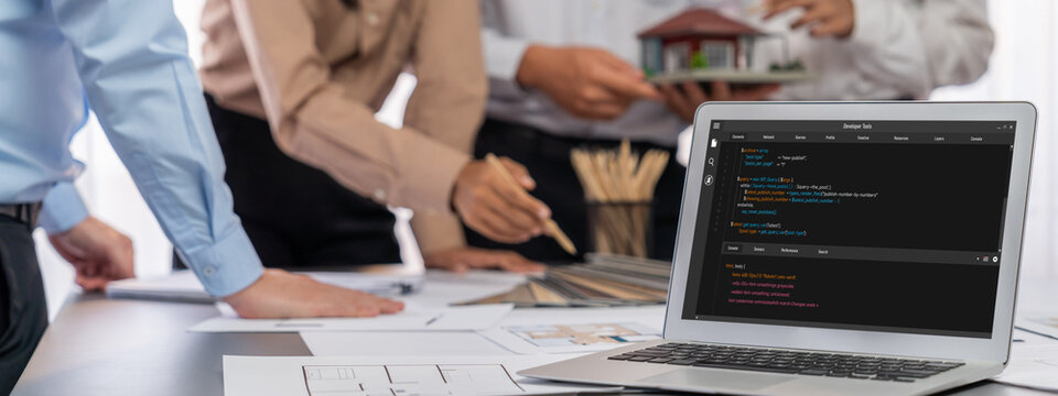 Group of interior architect designer discussing together on blueprint and laptop screen display architecture software for more precise designing layout. Modern home design and renovation. Insight