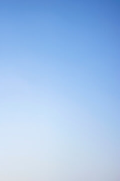 Seamless clear blue sky gradient background with a smooth transition from vibrant azure to soft pale white, perfect for clean atmospheric overlays and versatile graphic design.