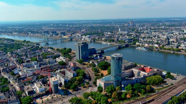 Aerial drone view of Cologne from Deutz with the KolnTriangle tower, Rhine River, Deutzer Bridge, Severinsbrucke, the old town and Great St Martin church, Germany, in summer.
