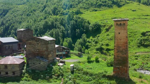 Svan tower district passes in circling aerial view through historic Chazhashi homes and lanes, supporting architectural conservation, medieval history, ethnography and Georgian heritage tourism media.